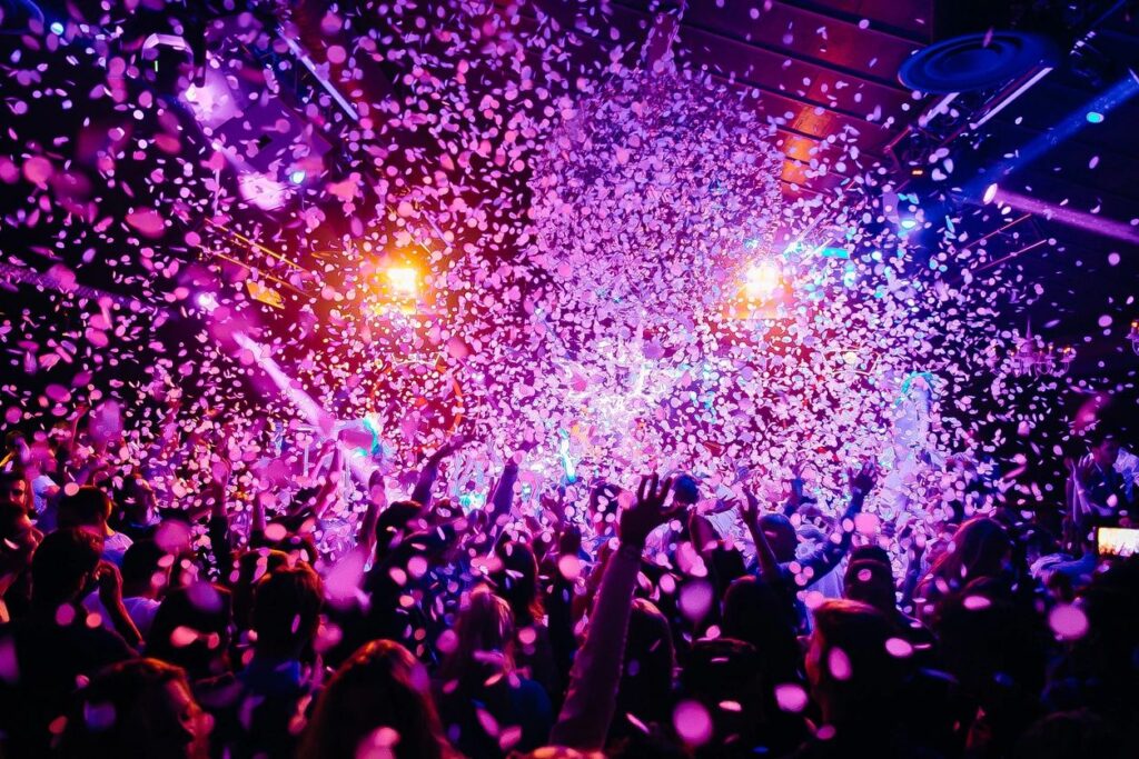 A crowd cheering with confetti