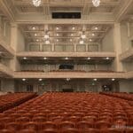 Empty theater auditorium with chandeliers and balconies