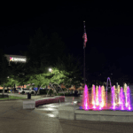 Colorful illuminated fountain at night plaza