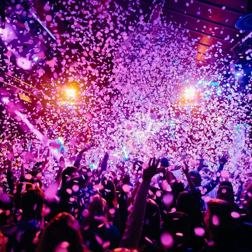 A crowd cheering with confetti